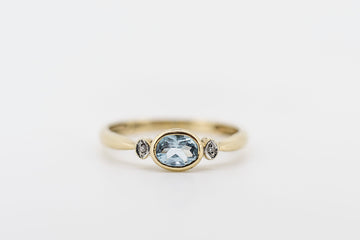 10ct gold ring with synthetic blue aquamarine and CZ stones