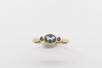 10ct gold ring with synthetic blue aquamarine and CZ stones