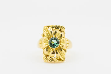 Floral designed 18ct gold ring with a green elbaite stone.